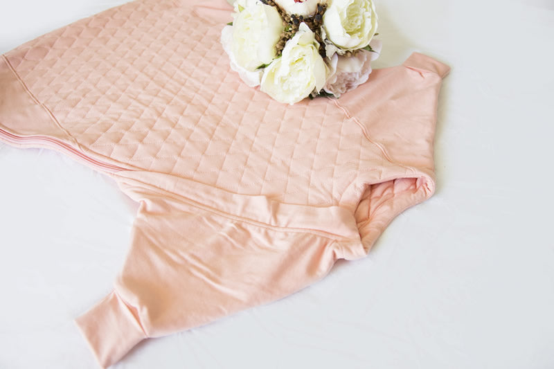 The Sleepy Hugs sleep sack for gentle swaddle transitioning, has a two way zipper top and bottom opening for easy diaper changes, the wide sack design is hip-friendly and fits a hip-dysplasia brace, helps startle reflex, perfect for tummy rollers.